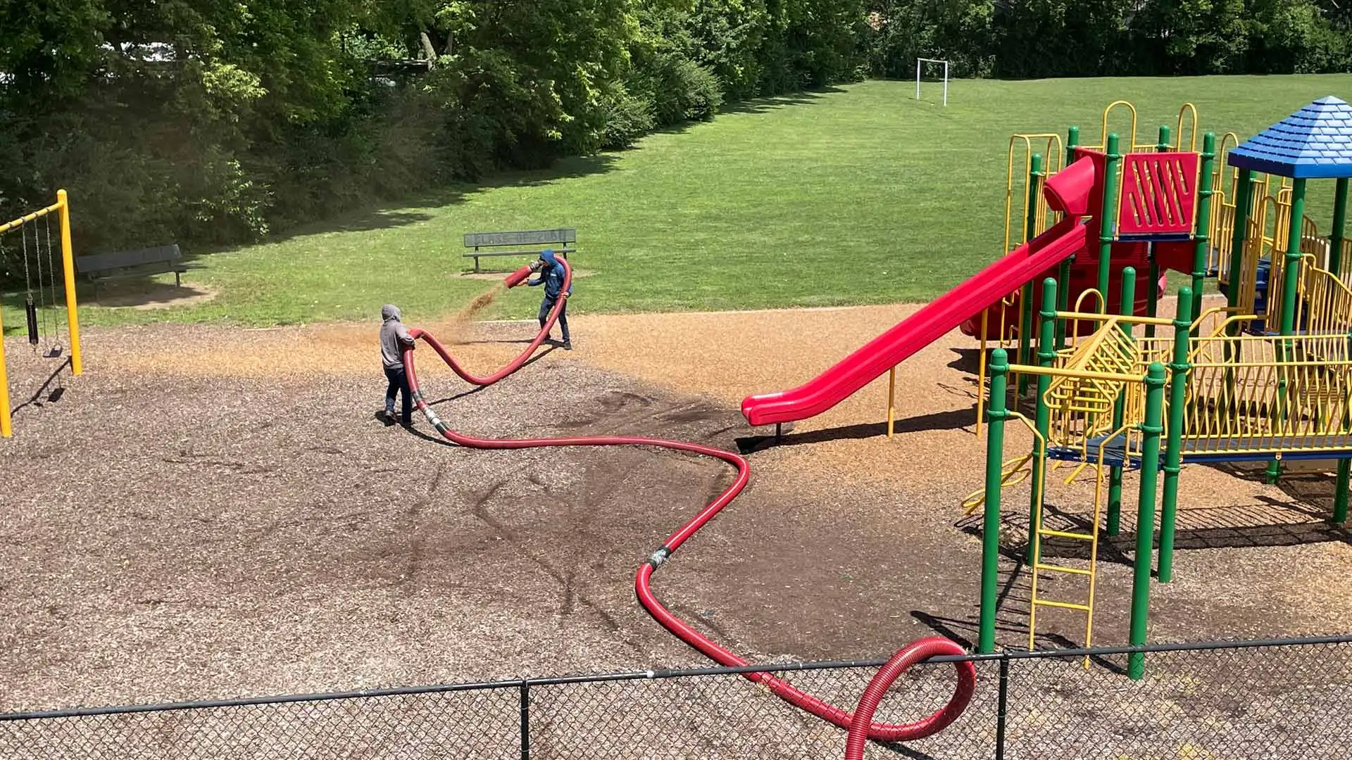 Professionals applying mulch to playground in Indiana.